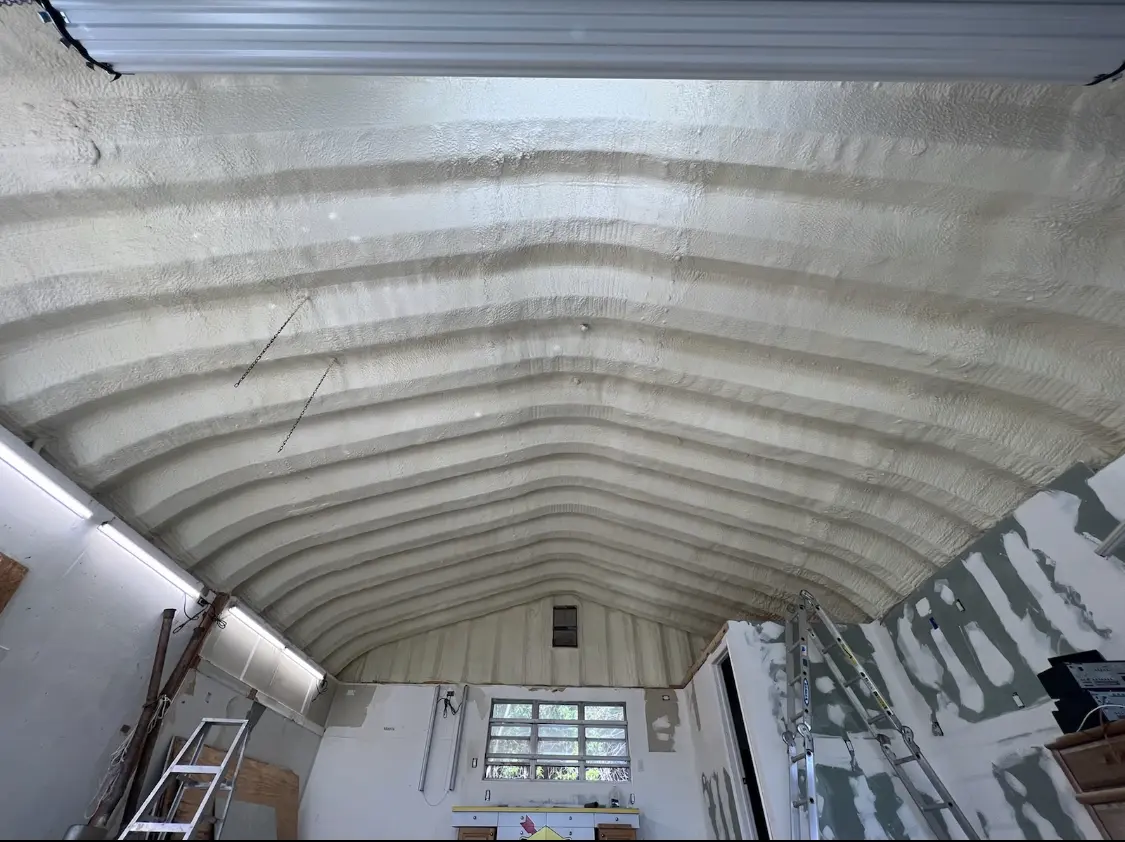 Spray polyurethane foam applied to the underside of a metal roof deck in Carver